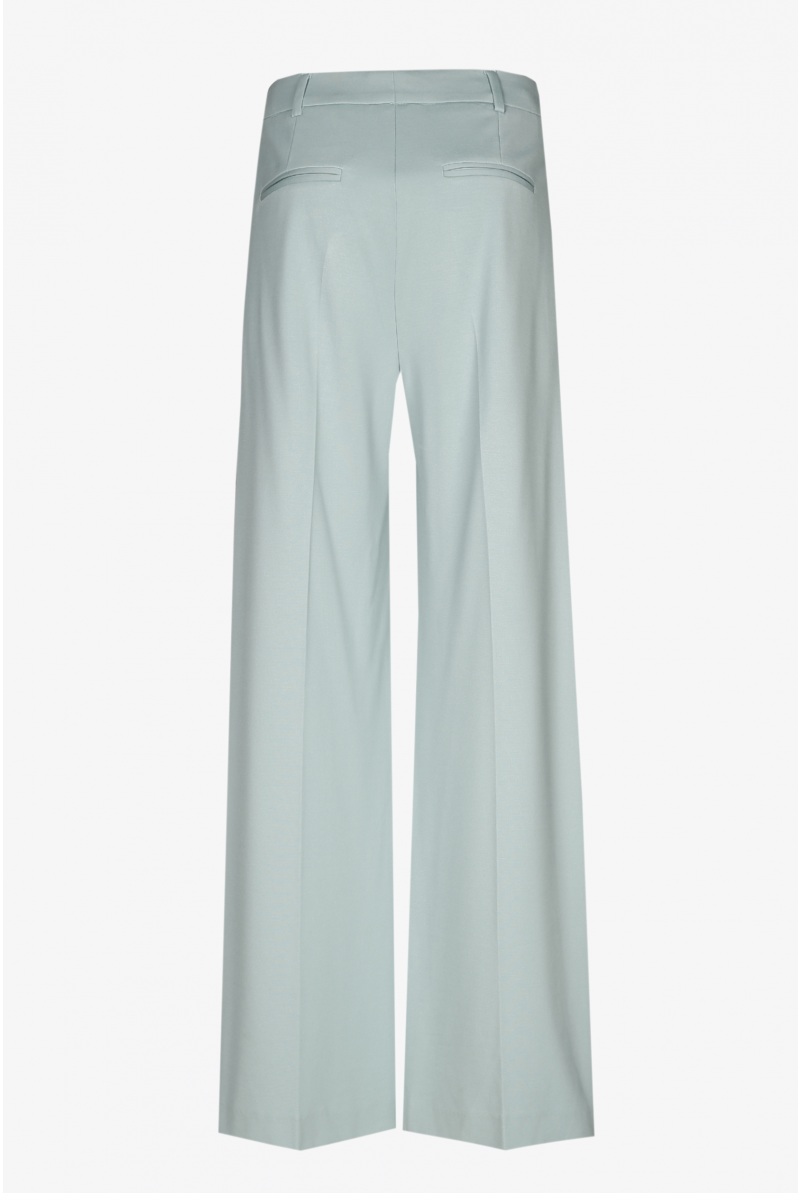 Wide mint green trousers with a pressed crease