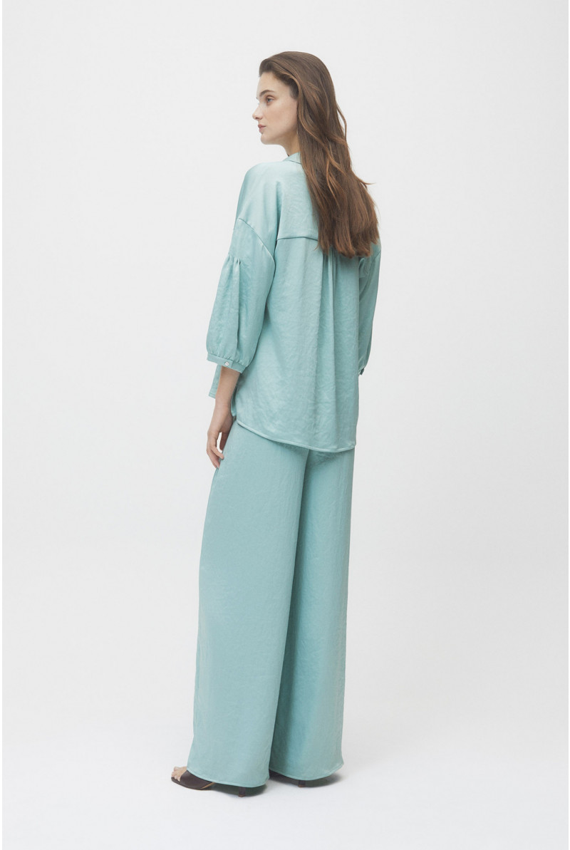 Light blue trousers with loose fit and elastic at the waist