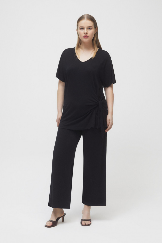 Black trousers with wide legs.